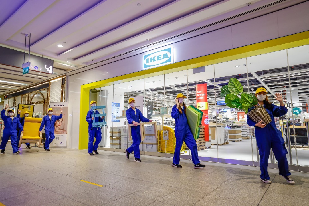 IKEA Jurong co-workers walking outside the store with products